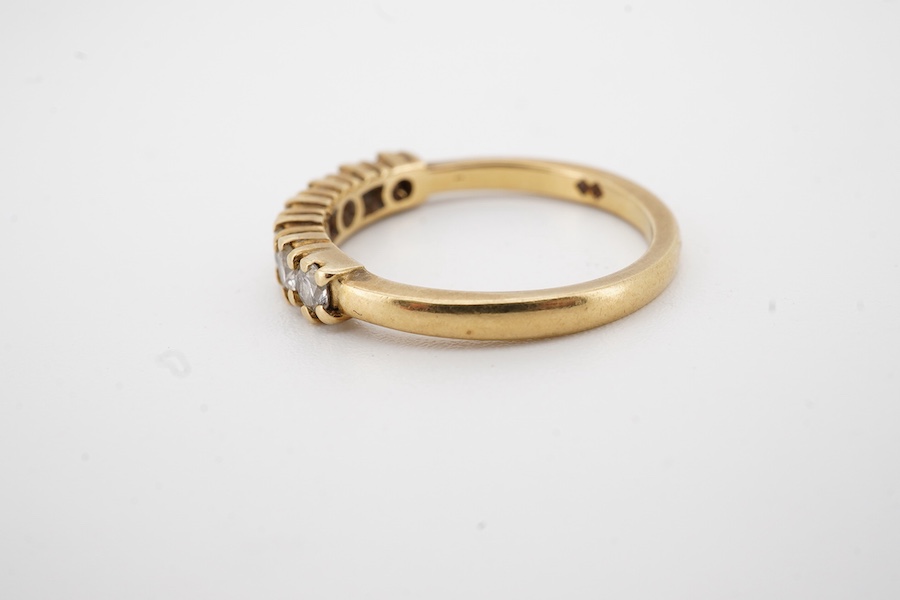 A modern 18ct gold and seven stone diamond set half hoop ring size O, gross weight 3.2 grams.